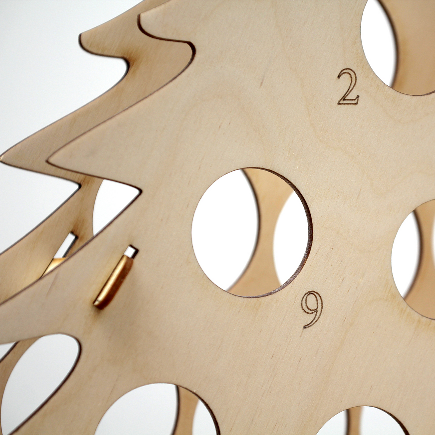 Detail of laser engraving on plywood bottle tree advent calendar