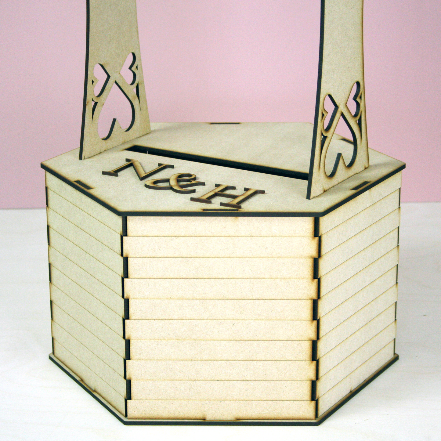 MDF wishing well shaped postbox for cards in front of pink background